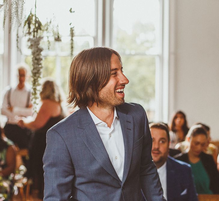 Groom in Relaxed Blue Blazer and White Shirt Waiting the Altar for his Bride