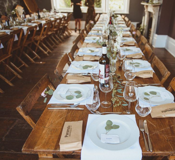 Reception with Wooden Tables, White Tableware and Foliage Decor