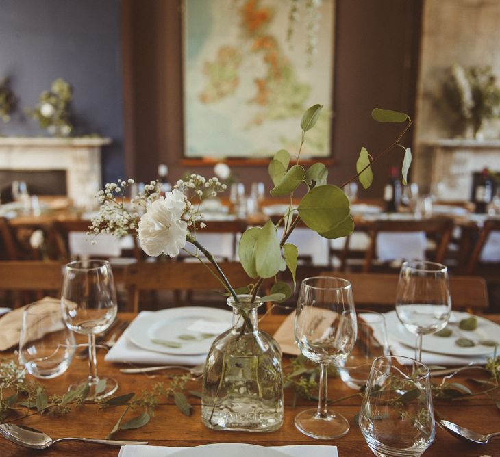 White Flower and Eucalyptus Flower Stems in Bottles