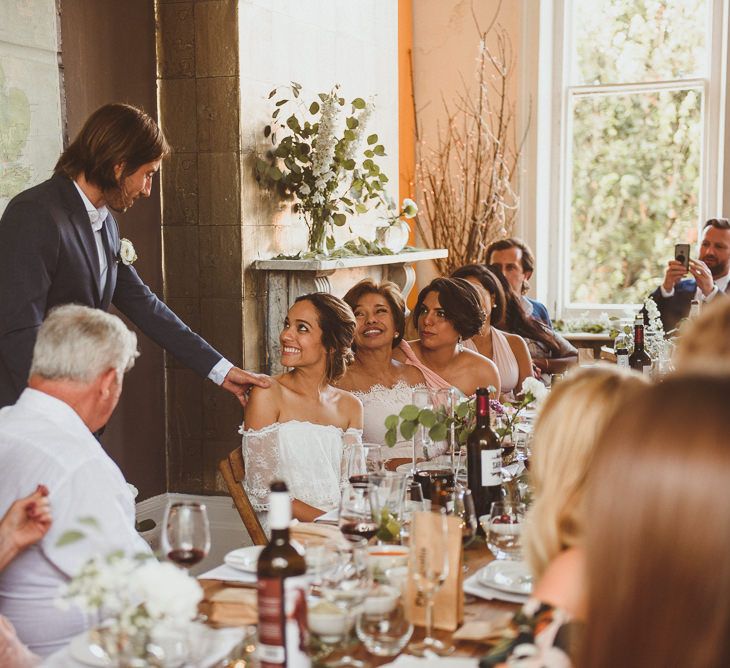 Groom in Black Trousers, White Shirt and Blue Blazer Reading His Wedding Speech