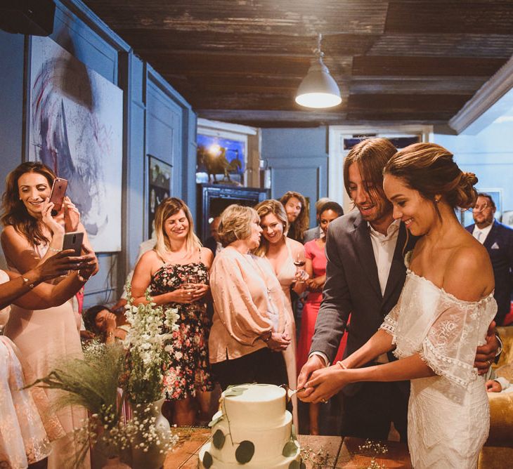 Bride and Groom Cutting The Cake