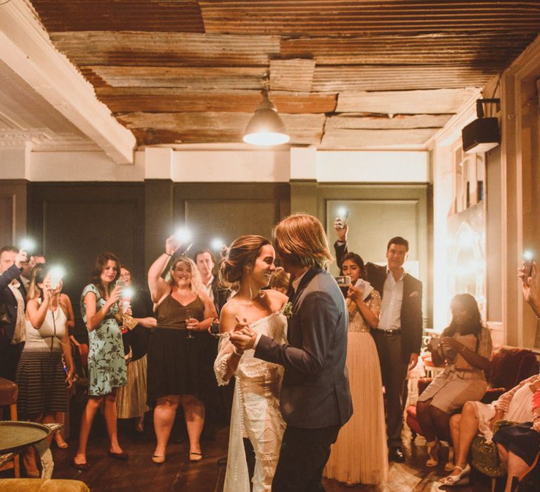 Bride in Off The Shoulder Grace Loves Lace Dress and Groom in Blue Blazer  During First Dance