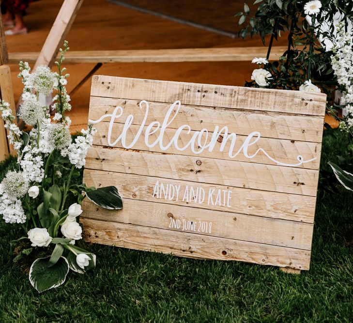 Wooden Welcome Sign For Wedding // Bride In Floral Dress By Stephanie Allin Festival Wedding With Food Trucks &amp; Outdoor Ceremony With Geo Dome Tent Baya Hire Epic Love Story Photography