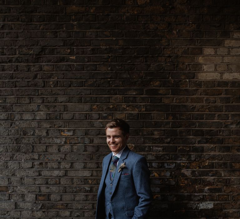 Groom In Navy Three Piece Suit // Christmas London Fields Brewery Wedding With Bride In Bespoke Dress By Katrine Mikklesen And Images From Taylor Hughes Photography