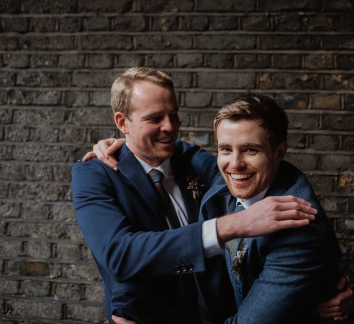 Groom In Navy Three Piece Suit // Christmas London Fields Brewery Wedding With Bride In Bespoke Dress By Katrine Mikklesen And Images From Taylor Hughes Photography