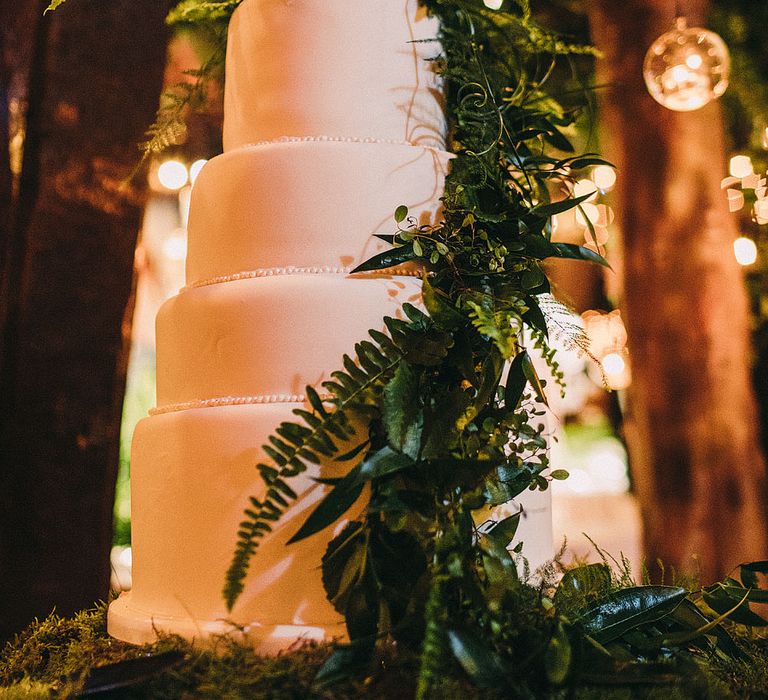 White Wedding Cake with Foliage Decor | Botanical Black Tie Wedding at Rivington Hall Barn with Acrylic Candelabras &amp; Louis Ghost Chairs | Lawson Photography | Ever After Videos