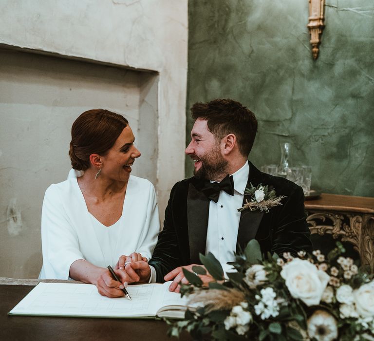 Bride and groom tie the knot at winter wedding with white floral bouquet