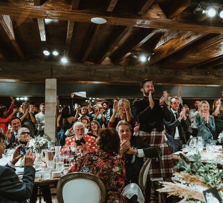 Guests enjoy winter wedding with cosy stying and foliage table decor