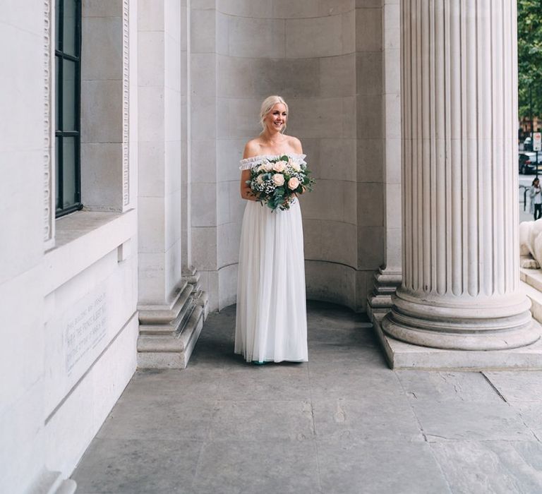 Bride in tulle maternity wedding dress from the high street