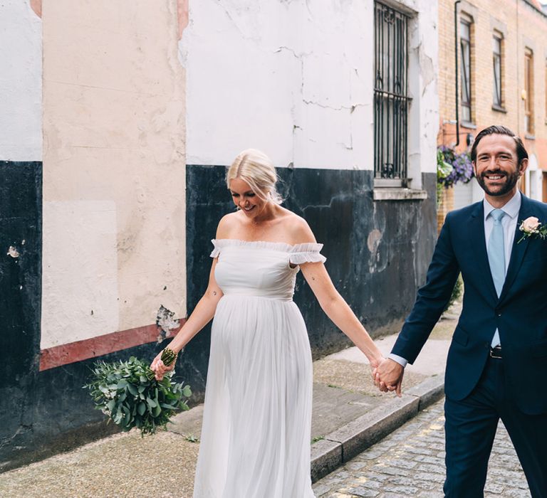 Bride and groom portrait walking through London streets