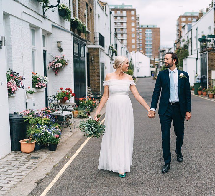 Bride and groom portrait hand in hand in London