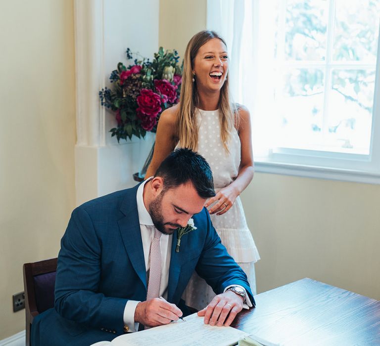 Bride and Groom Sign The Wedding Register