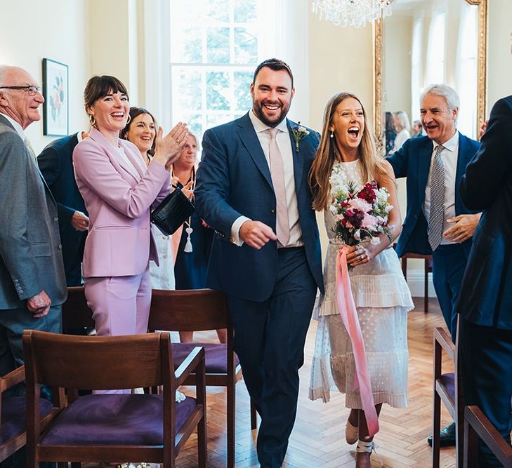 Bride and Groom Walk Back Up Aisle After Ceremony