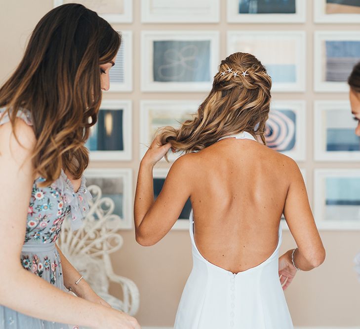 Bride Putting on Her Backless Made With Love Wedding Dress on the Wedding Morning