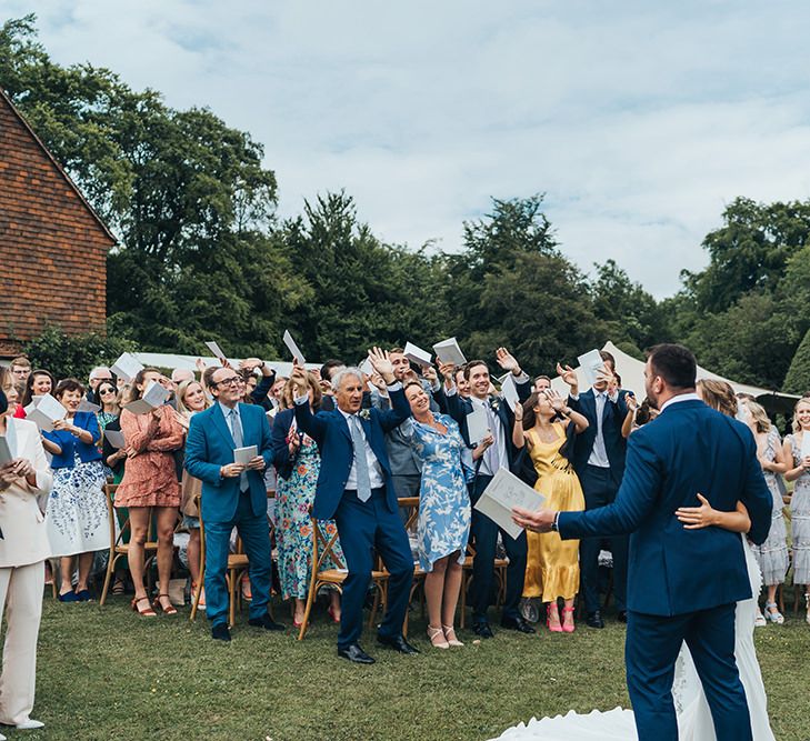 Wedding Guests Cheering at the Outdoor Wedding Ceremony