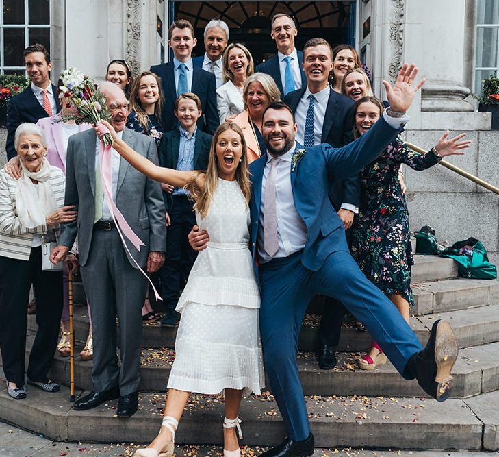 Bride and Groom On Steps Of Town Hall