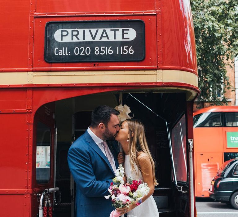 Bride and Groom Kiss On Red Bus Wedding Transport