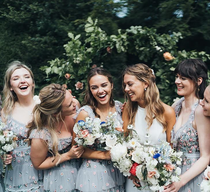 Bridal Party Portrait Bride in Made With Love Wedding Dress Laughing with Her Bridesmaids in Needle and Thread Dresses