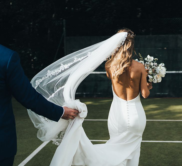 Bride in Backless Made With Love Wedding Dress with Button Detail