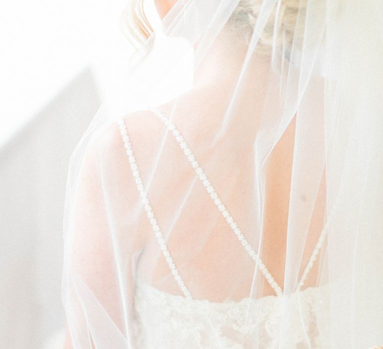 Bride in Lace Wedding Dress with Spaghetti Straps and Cathedral Veill