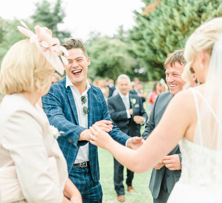 Wedding Guest in Blue Checked Suit Laughing with Bride