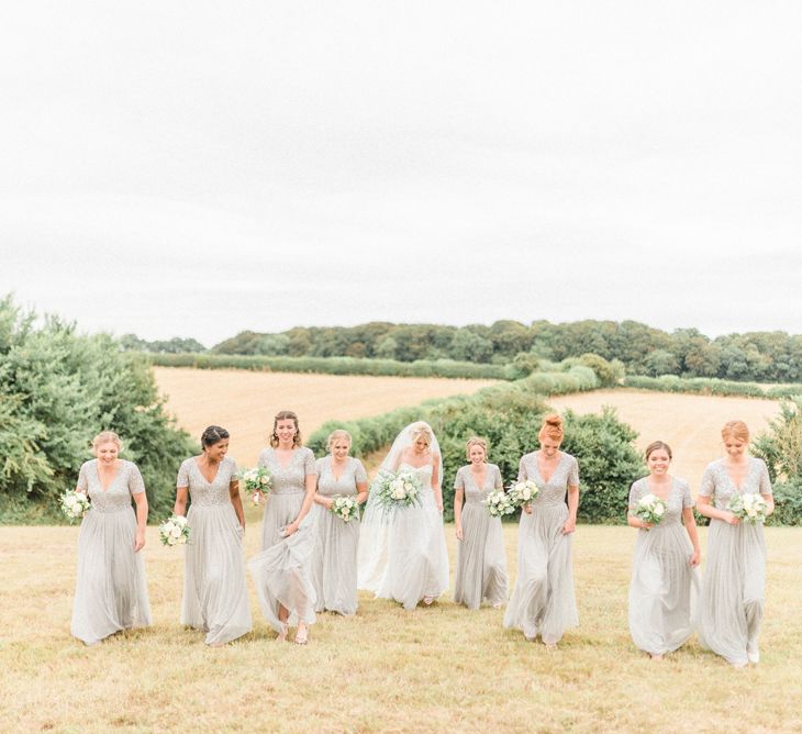 Bridal Party Portrait with Bridesmaids in Grey Sequin &amp; Tulle Dresses and Bride in Romantic Wedding Dress with Straps