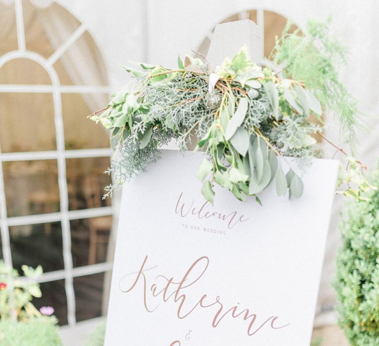 White Wedding Welcome sign with Gold Foil Font and White and Green Flower Decor