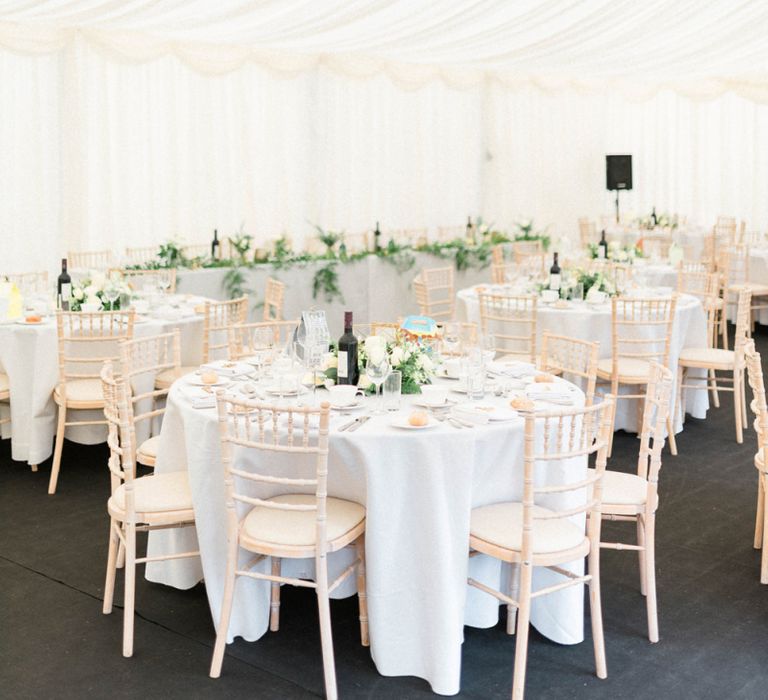 Elegant marquee Reception with Gold and Green Wedding Flowers