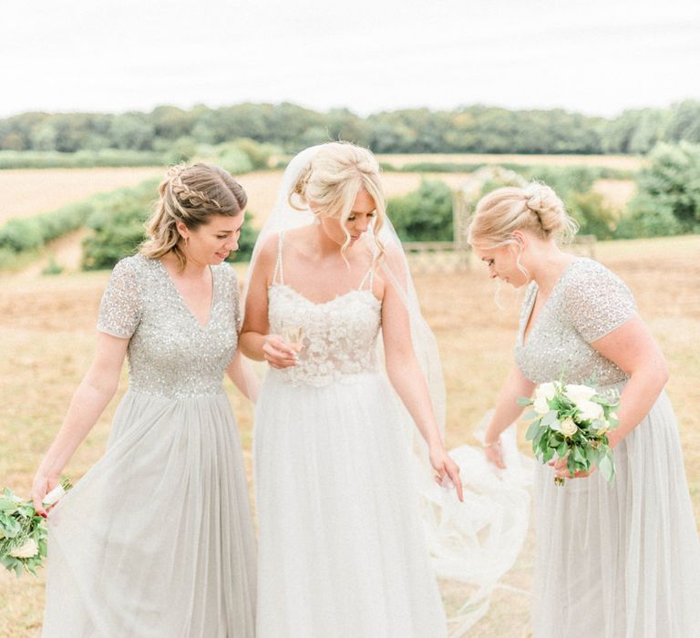 Bride in Lace Wedding Dress with Spaghetti Straps and Cathedral Veil and Bridesmaids in Maya Sequin Dresses