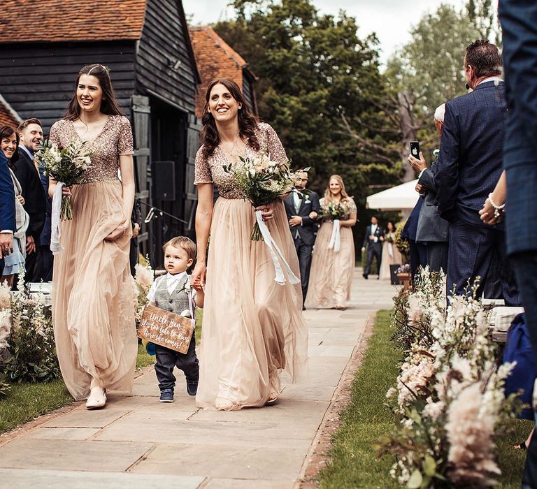 Bridesmaids In Pink Dresses Walk Down The Aisle