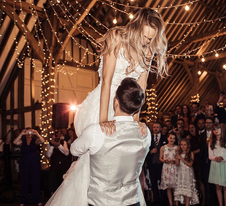 Bride and Groom First Dance In Barn Wedding with Fairy Lights