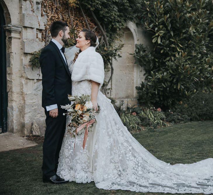 Bridal Faux Fur Cover Up For Winter Wedding With Groom In Tux at Oxfordshire Wedding Venue