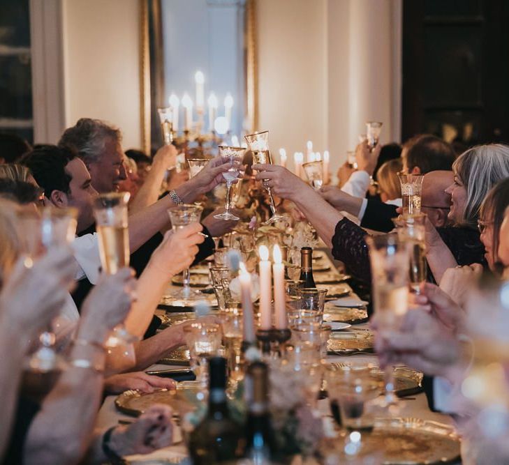 Guests Toast Bride and Groom During Speeches at Kirtlington Park Wedding Venue