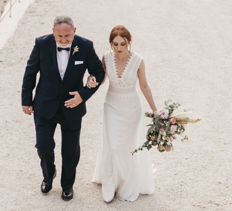 Father of the Bride in a Tuxedo and Bride in a Fitted Pronovias Wedding Dress Walking to the Wedding Ceremony