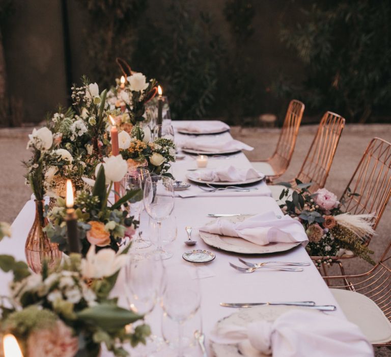 Candles and Vessels Filled with Peach Flowers