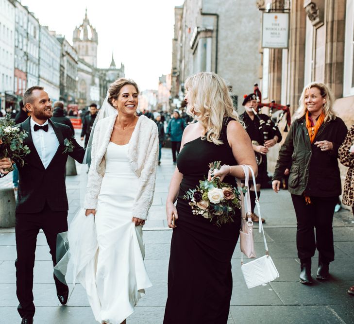 Bride and groom walking the city streets at Edinburgh elopement