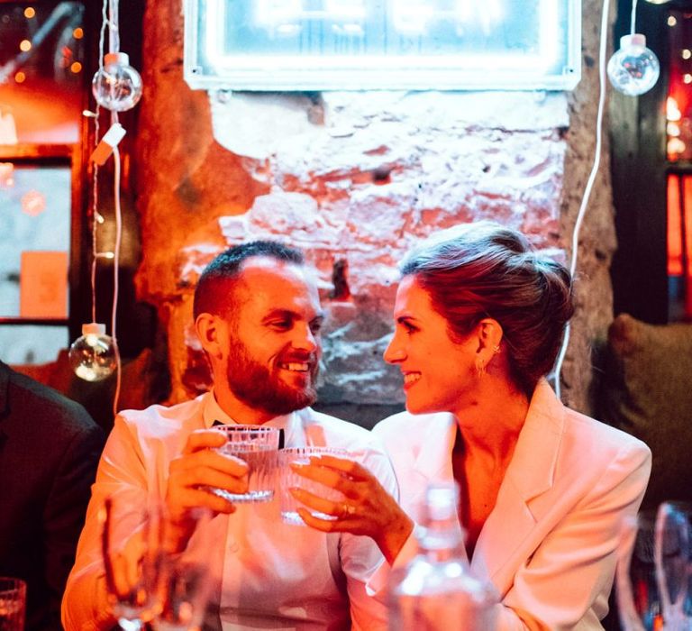 Bride and groom toasting at their Basement Bar reception