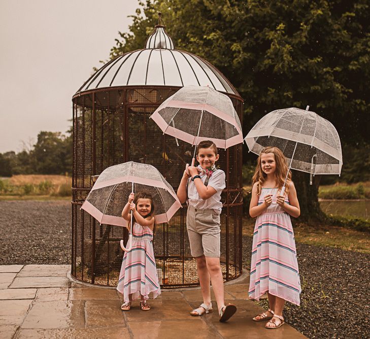 Children Holding Umbrellas