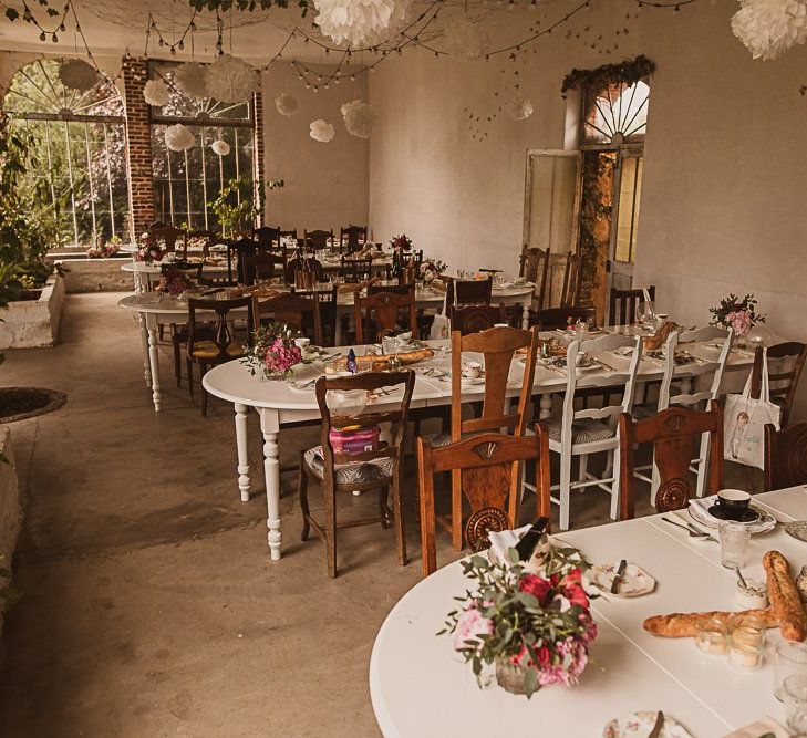 Wedding Reception Decor with Mismatch Chairs, Festoon Lights and Pompoms featured on escape to the chateau