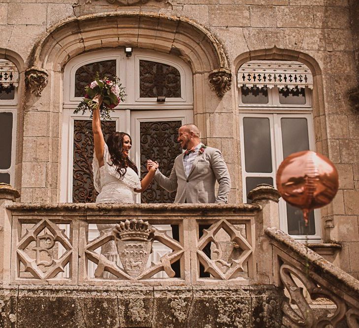 Bride and Groom Cheering on the Steps of their French Chateau de la Motte Husson Wedding