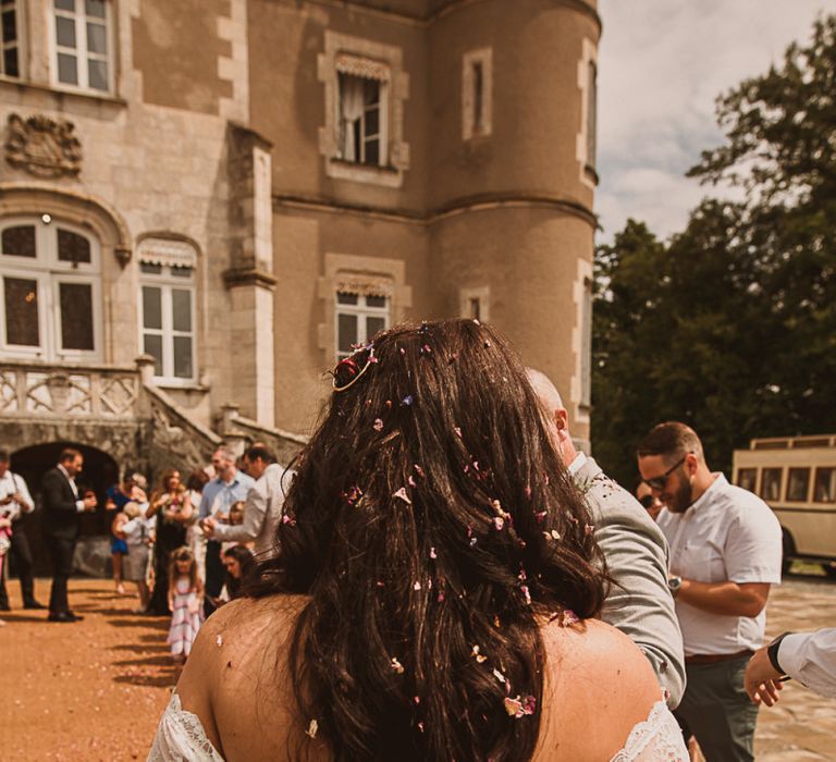 Bride in Off the Shoulder Wedding Dress and Down Hair Covered in Confetti