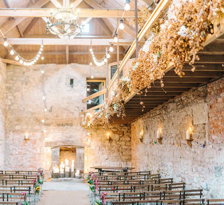 Doxford Barns Wedding Venue | Sunflower Pew Ends | Candle Altar | Festoon Lights | Colourful Paper Cranes &amp; Sunflower Wedding Décor in Rustic Barn | Sarah-Jane Ethan Photography