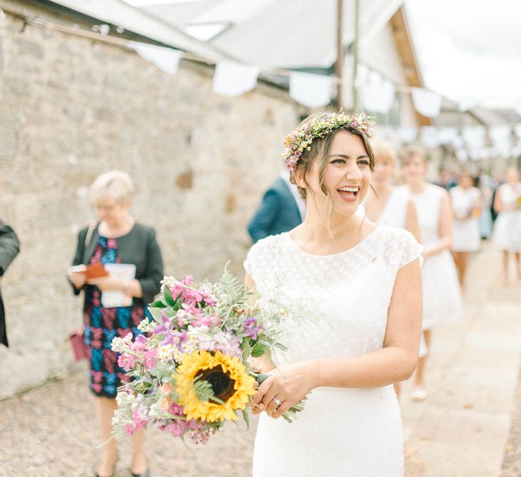 Bride in Chiffon Polka Dot Dress by Kate Halfpenny | Bridal Flower Crown | Bright Bouquet with Sunflowers | White Bunting | Colourful Paper Cranes &amp; Sunflower Wedding Décor in Rustic Barn | Sarah-Jane Ethan Photography