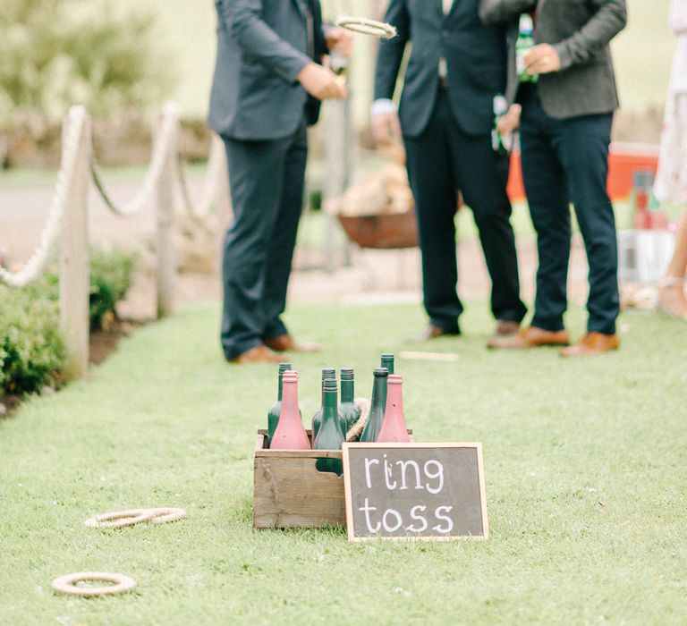 Ring Toss Garden Game at Wedding Reception | Colourful Paper Cranes &amp; Sunflower Wedding Décor in Rustic Barn | Sarah-Jane Ethan Photography