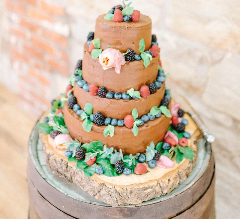 Four Tier Homemade Wedding Cake with Chocolate Icing and Berries | Polaroid Picture Cake Topper | Log Slice Base for Wedding Cake | Colourful Paper Cranes &amp; Sunflower Wedding Décor in Rustic Barn | Sarah-Jane Ethan Photography