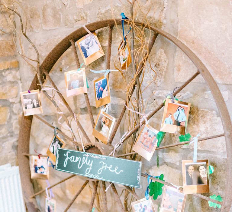 Rustic Wooden Wheel Displaying Family Tree | Colourful Paper Cranes &amp; Sunflower Wedding Décor in Rustic Barn | Sarah-Jane Ethan Photography