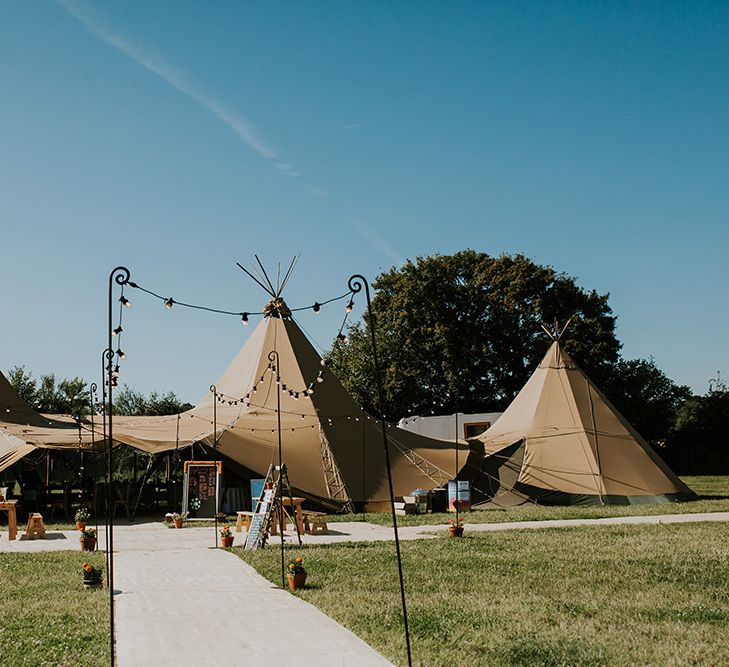 PapaKata tipi at Hampshire wedding venue with bright decor and canary yellow bridesmaid dresses