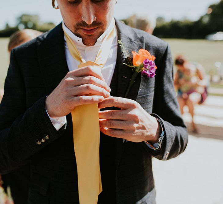 Groom wears yellow tie to match the canary yellow bridesmaid dresses