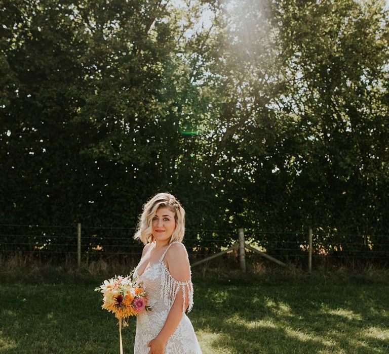 Bright wedding flowers with off-the-shoulder wedding dress