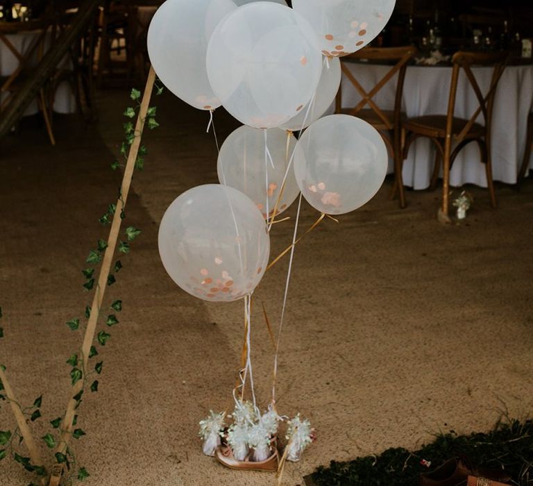 Wedding balloons at celebration with bright decor and canary yellow bridesmaid dresses